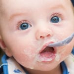 Small baby spoon-feeding